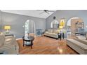 Inviting living room with hardwood floors, neutral walls, comfortable seating, and arched entryways at 1331 Red Hill Rd, Marietta, GA 30008