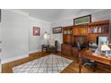 A cozy home office with hardwood floors and a large built-in bookcase, perfect for remote work at 3560 Greenside Ct, Dacula, GA 30019