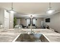 Modern stainless steel kitchen sink and faucet overlooking an expansive living space at 55 Forest Rd, Stockbridge, GA 30281