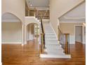Elegant foyer with hardwood floors, a staircase with decorative iron railings, and natural light at 917 Saints Ct, Marietta, GA 30068