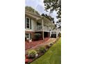 Spacious exterior with a ramp, a covered porch, and a walkway lined with flowers at 5904 Clairmont Way, Powder Springs, GA 30127