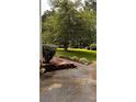 Beautifully maintained yard with landscaping, mulch and mature trees for shade at 5904 Clairmont Way, Powder Springs, GA 30127