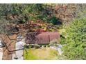 Aerial view of the charming brick home surrounded by mature trees on a large lot at 9491 Hidden Branch Dr, Jonesboro, GA 30236