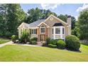 Stunning two-story home featuring a lush lawn and mature trees in a serene, wooded setting at 1811 Ascot Nw Cv, Acworth, GA 30102