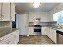 Beautiful kitchen featuring stainless steel appliances, granite countertops, and bright white cabinets at 1011 Darvin Nw Ln, Kennesaw, GA 30144