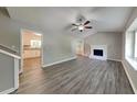 Bright living room with hardwood floors, a ceiling fan, and a fireplace at 1011 Darvin Nw Ln, Kennesaw, GA 30144
