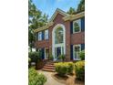 Close up of a brick home with a large arched window above the front door and steps at 755 Creek Wind Ct, Johns Creek, GA 30097