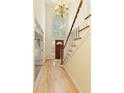 Bright foyer with hardwood floors, high ceilings, a chandelier, staircase and a large arched window at 755 Creek Wind Ct, Johns Creek, GA 30097