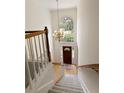 Foyer with high ceilings, a chandelier, staircase and a large arched window viewed from above at 755 Creek Wind Ct, Johns Creek, GA 30097