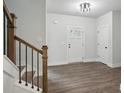 Inviting entryway with hardwood floors, a staircase, and a stylish front door that brings in light at 3131 Stonegate Sw Dr, Atlanta, GA 30331