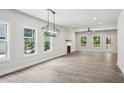 Bright living room with sleek floors, large windows, modern lighting, and a fireplace with a mantle at 3131 Stonegate Sw Dr, Atlanta, GA 30331