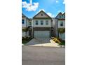 Charming townhome features stone accents, a two-car garage, and professionally landscaped front yard at 428 Whitetail Cir, Canton, GA 30115