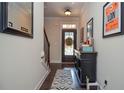Inviting home entryway with hardwood floors, staircase, and a decorative mirror and console at 2436 Loughridge Dr, Buford, GA 30519