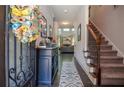 Inviting home entryway with beautiful hardwood floors, staircase, and view to the living area at 2436 Loughridge Dr, Buford, GA 30519
