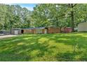 Traditional brick home with sprawling lawn, mature shade trees and detached garage at 6600 N Beulah Rd, Lithia Springs, GA 30122