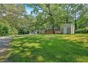 Traditional brick home with mature trees, detached garage and spacious front yard at 6600 N Beulah Rd, Lithia Springs, GA 30122