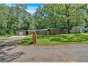 Traditional brick home with mature trees, detached garage and spacious front yard at 6600 N Beulah Rd, Lithia Springs, GA 30122