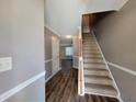 Entryway with wood-look flooring, stairs to the second level, and neutral paint at 285 Fieldview Ln, Covington, GA 30016