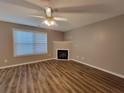 Living room featuring a fireplace, hardwood floors, and natural light at 285 Fieldview Ln, Covington, GA 30016