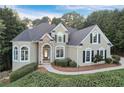 Charming two-story home with manicured landscaping, stone accents, and a welcoming walkway at 3845 Overlake Dr, Cumming, GA 30041