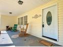 Covered front porch with seating and decor, creating a welcoming entrance to the home at 7680 Banks Mill Road Rd, Douglasville, GA 30135