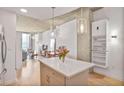 Open concept living space with hardwood floors, modern lighting, and exposed concrete ceiling at 860 Peachtree St # 1103, Atlanta, GA 30308