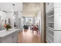 Open concept living space with hardwood floors, modern lighting, and exposed concrete ceiling with city views at 860 Peachtree St # 1103, Atlanta, GA 30308