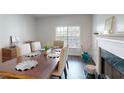 A well-lit dining room complemented by a fireplace and window at 3275 Lenox Ne Rd # 413, Atlanta, GA 30324