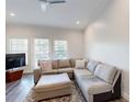 Spacious living room featuring a comfortable gray sofa and an area rug at 3275 Lenox Ne Rd # 413, Atlanta, GA 30324