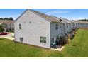 Townhome backyard with ample space and views of neighboring houses, green space, and a partial fence at 161 Swindon Dr, Mcdonough, GA 30253