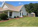The backyard features a well-manicured lawn and a glimpse of an outdoor gazebo, ideal for relaxation and entertaining at 345 Annslee Circle Cir, Loganville, GA 30052