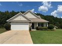 Charming single-story home with well-manicured lawn, attached two-car garage, and neutral siding at 345 Annslee Circle Cir, Loganville, GA 30052