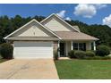 Charming single-story home featuring a two-car garage, well-maintained lawn, and traditional architectural details at 345 Annslee Circle Cir, Loganville, GA 30052