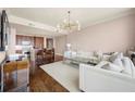 Open-concept living room with kitchen features hardwood floors, bright lighting, and comfortable seating at 3630 Peachtree Ne Rd # 2706, Atlanta, GA 30326