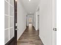Inviting foyer featuring hardwood floors and neutral walls with entry to other rooms at 114 Crooked Lake Park, Villa Rica, GA 30180