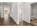 Bright hallway with hardwood flooring leading to bedrooms and open-concept living area at 114 Crooked Lake Park, Villa Rica, GA 30180