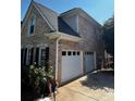 Spacious two-car garage with a brick exterior and a well-maintained driveway, offering convenient parking at 2550 Lynshire Ln, Snellville, GA 30078