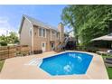 A refreshing backyard pool with a spacious patio and comfortable seating for outdoor relaxation at 2775 Harper Ferry Dr, Lawrenceville, GA 30044