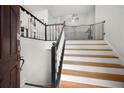 Welcoming entryway with hardwood stairs, white railings, and freshly painted walls at 2775 Harper Ferry Dr, Lawrenceville, GA 30044