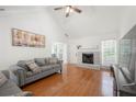Bright living room featuring a vaulted ceiling, hardwood floors, fireplace, and ample natural light at 2775 Harper Ferry Dr, Lawrenceville, GA 30044