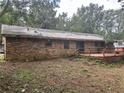 Brick home featuring a wooden deck surrounded by a yard at 4595 Sahara Sw Dr, Atlanta, GA 30331