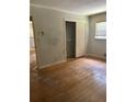 Bedroom featuring wood floors, neutral walls, closet, and a window at 4595 Sahara Sw Dr, Atlanta, GA 30331