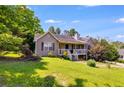 Beautiful home exterior featuring a covered porch and lush greenery at 80 Jacob Trl, Rockmart, GA 30153