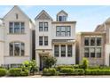 Charming two-story home with white brick exterior, black-framed windows, and professional landscaping at 506 Broadview Ne Pl, Atlanta, GA 30324