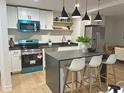 Modern kitchen with stainless steel appliances, white cabinets, and a center island with seating at 5310 Lyndale Cir, Forest Park, GA 30297