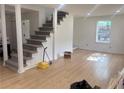 Bright living room with new flooring and a staircase at 5310 Lyndale Cir, Forest Park, GA 30297