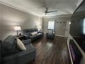 Cozy living room with hardwood floors, modern lighting, and comfortable seating at 127 Spring Way Sq, Canton, GA 30114