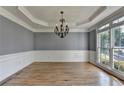Formal dining room with hardwood floors, wainscoting and chandelier lighting at 1723 Woodbow Path, Dacula, GA 30019