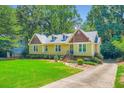 Charming home features a well-manicured lawn and inviting entrance with brick steps at 350 Lamplighter Se Ln, Marietta, GA 30067