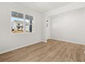 Bright room with hardwood floors, white walls, large window, and white trim at 104 Crooked Lake Park, Villa Rica, GA 30180